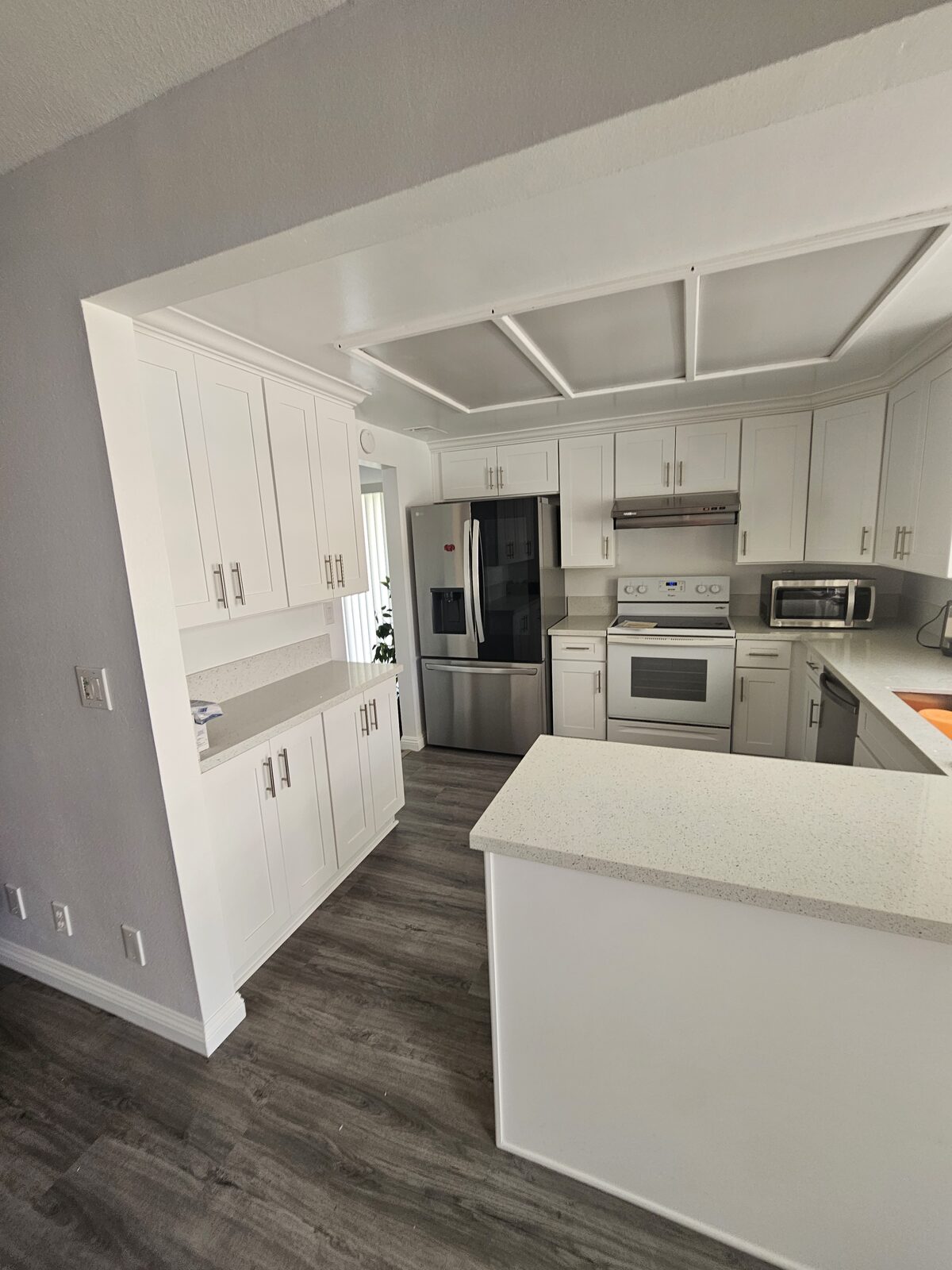 Kitchen remodel in Anaheim Hills with white shaker cabinetry, quartz counters and stainless appliances